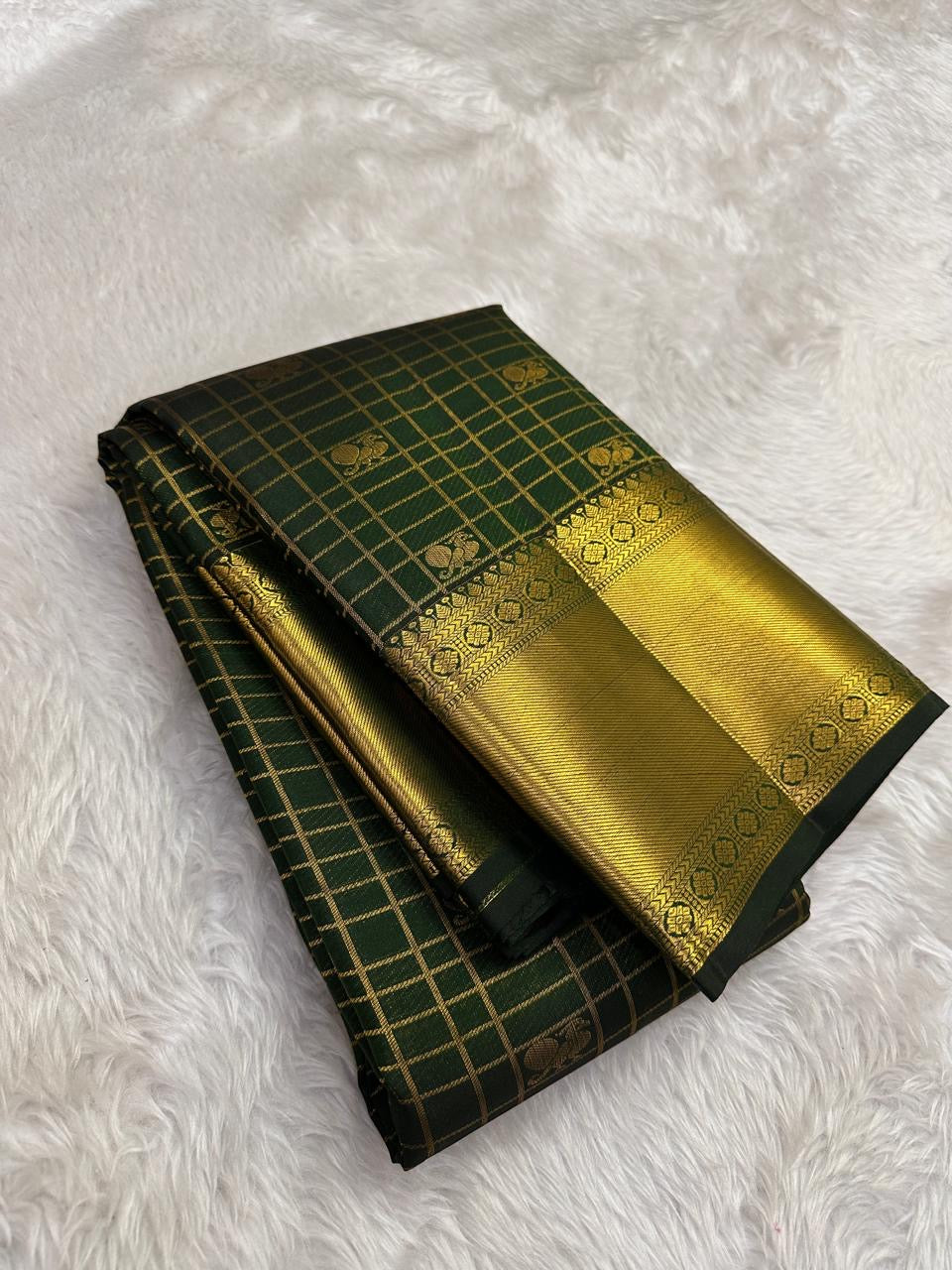 Folded view of hunter green pure silk Kanjivaram saree with Zari Kattam Gandaberunda Butta