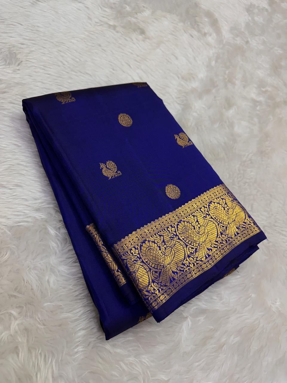 Authentic Kancheepuram silk saree featuring deep blue silk and intricate antique gold peacock weaving