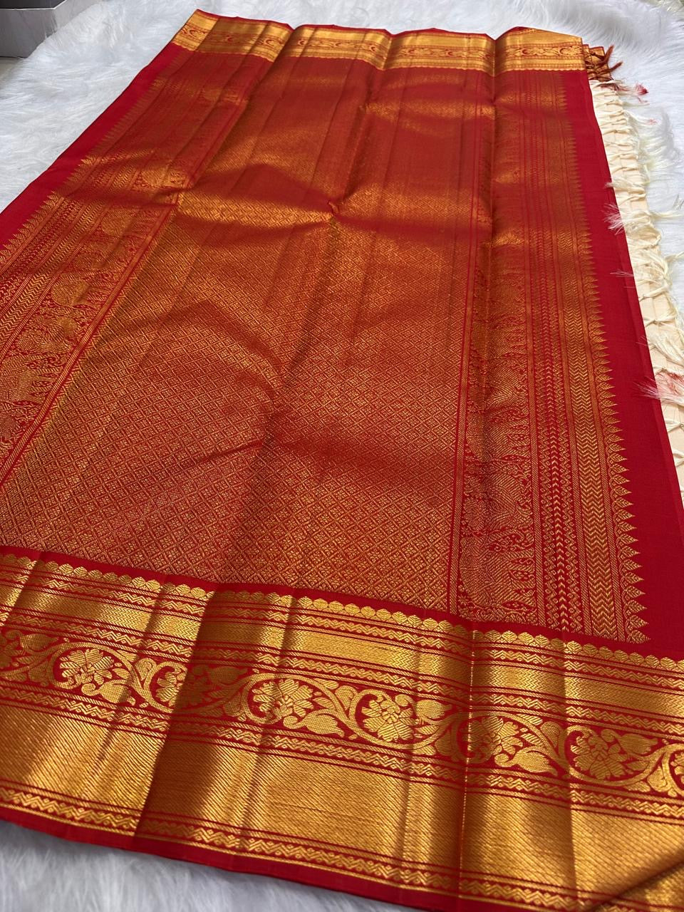 Ivory Korvai saree showing the broad Arakku red and gold zari border against the pale silk body.