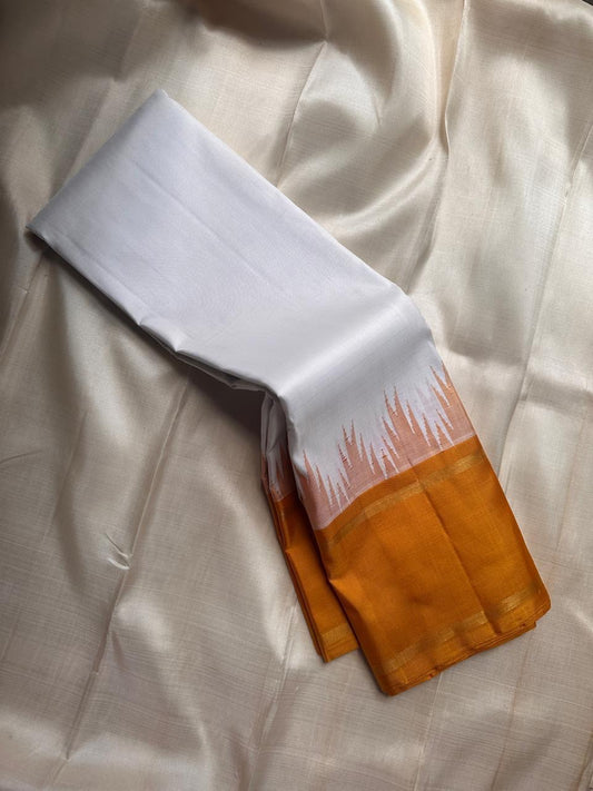 Kanjivaram silk saree featuring thazampoo reku border and ivory contrast body.