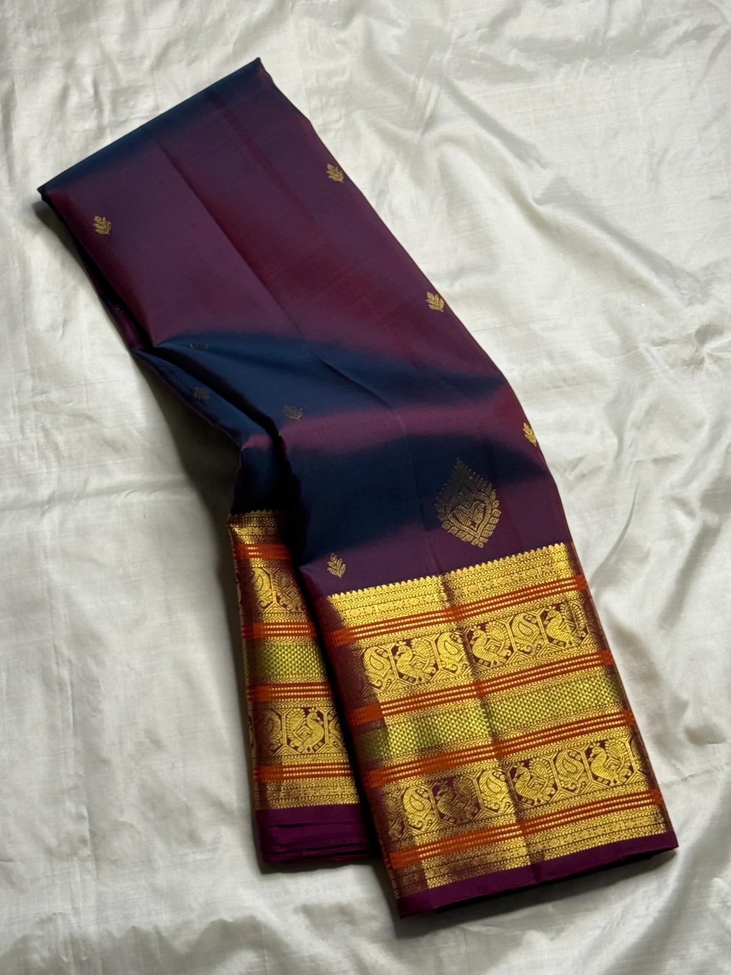 Close-up of maanga butta in gold zari on magenta double shade Kanjeevaram silk saree — Idam Living