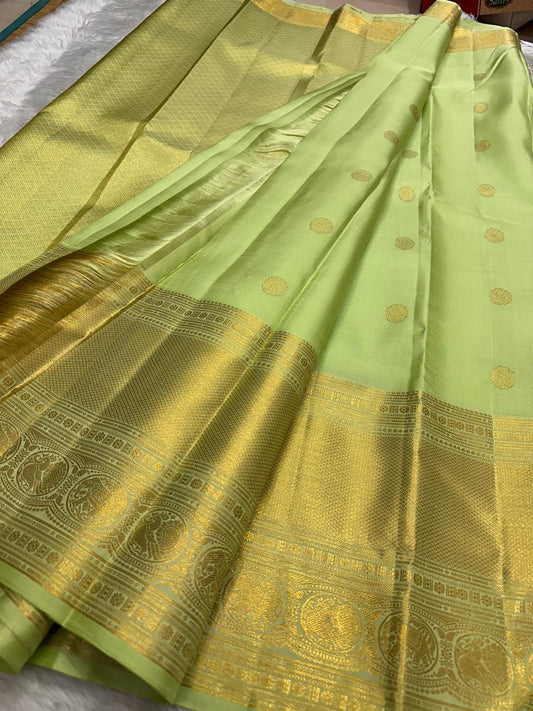 kanchipuram silk saree pastel pistachio with gold border close-up