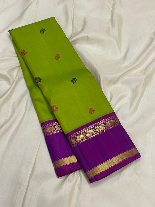 Chartreuse Kanjivaram silk saree with peacock motifs and deep violet zari woven border detail