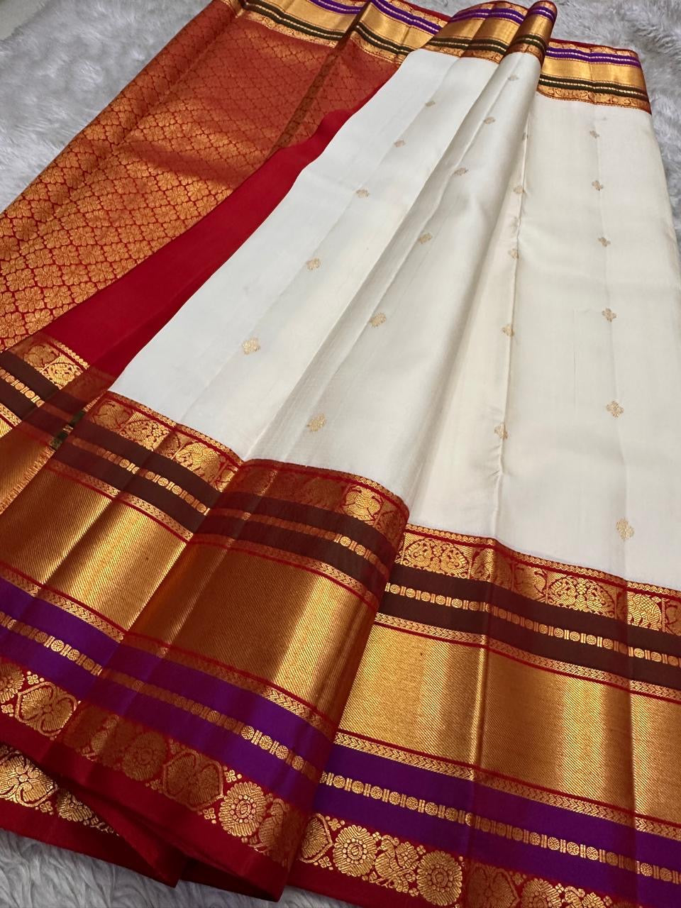 Wide view of the red pallu with gold zari motif grid and ornate zari border detailing, available in the USA.