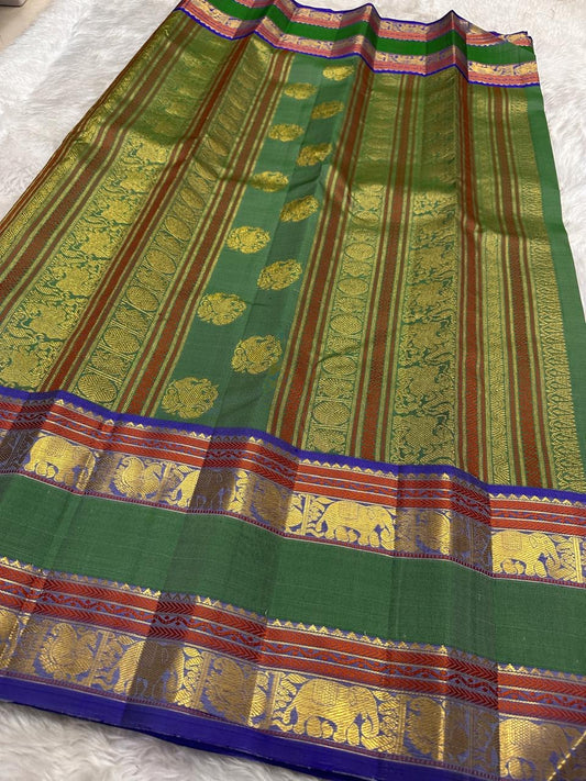Green Kanjivaram saree with blue rettapet zari border detail close up