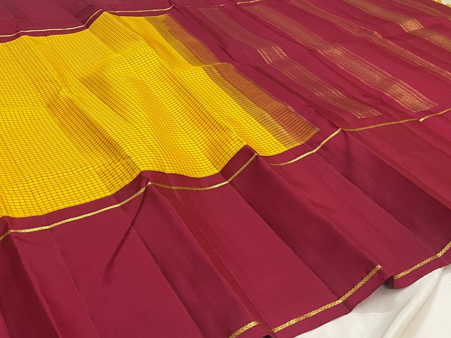 Kanjivaram silk saree saffron yellow full view with structured check pattern