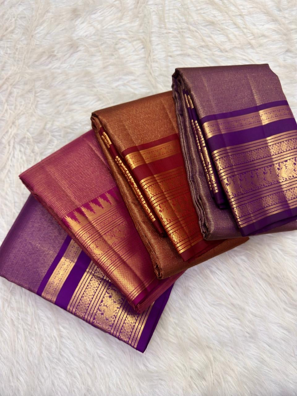 Idam Living handwoven Kanchipuram zari kattam silk sarees in purple, aubergine and arakku red, showing body, border and gold zari pallu