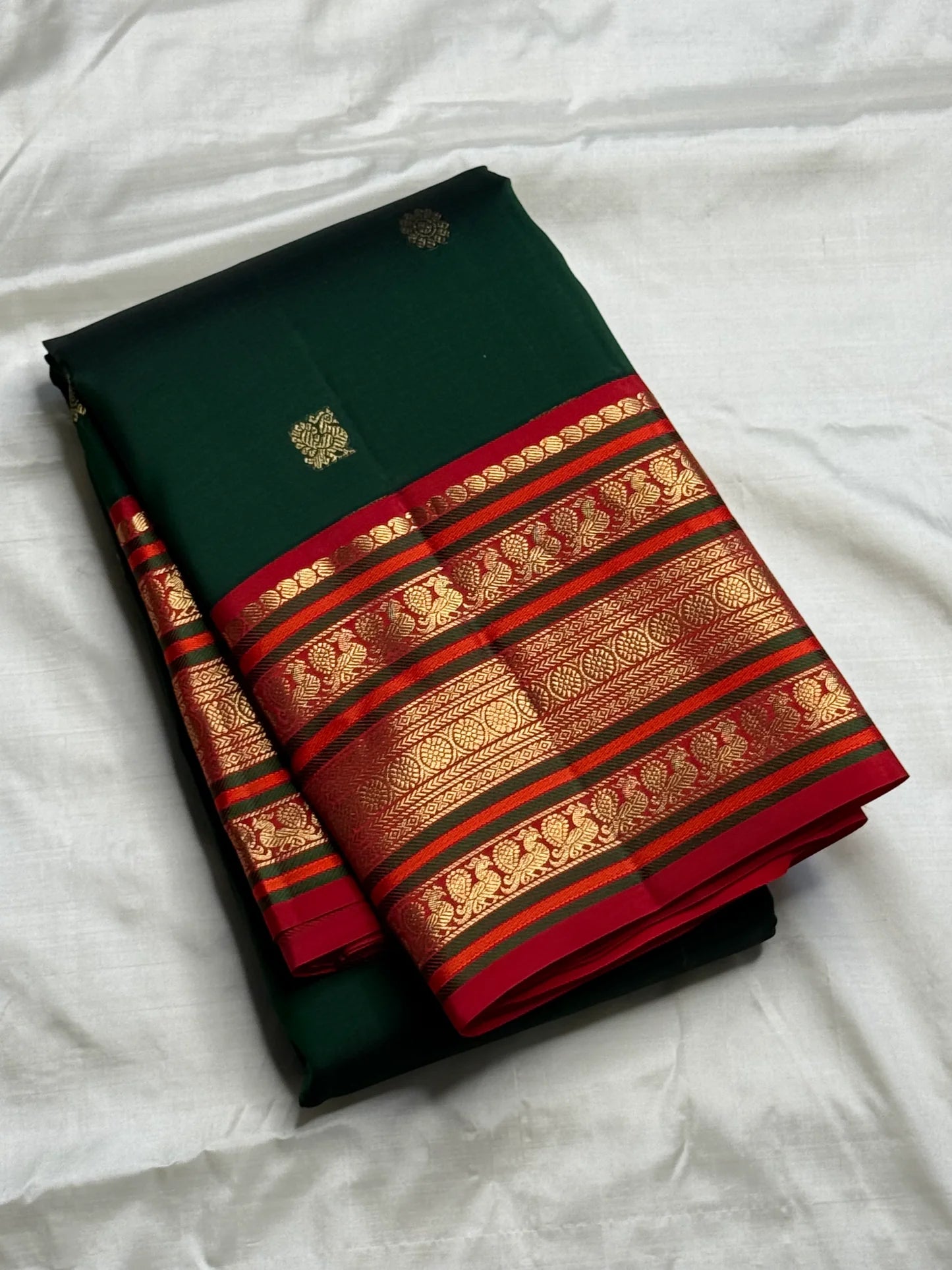 Detail view of gold zari weaving on chili red varisaipet border of pure Kanjivaram silk saree — Idam Living