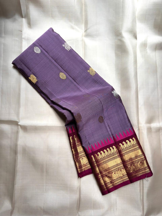 Kanjivaram silk saree in lilac with magenta contrast border and traditional zari detailing