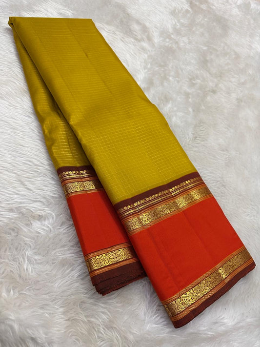 kanchipuram silk saree warm ochre yellow with orange glow border draped view