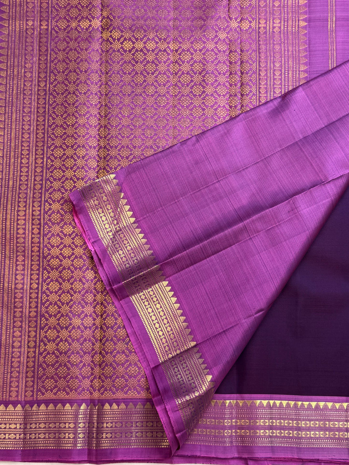 Pure silk Kanchipuram Butta saree with gold zari highlights on purple silk