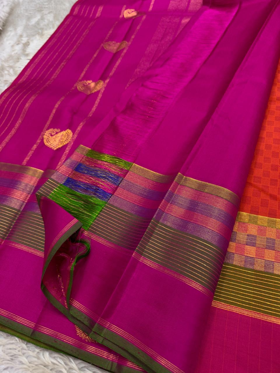 Orange Kanchipuram silk saree showing paimadi kattam checks with Vadamalli-pink and olive-green border.