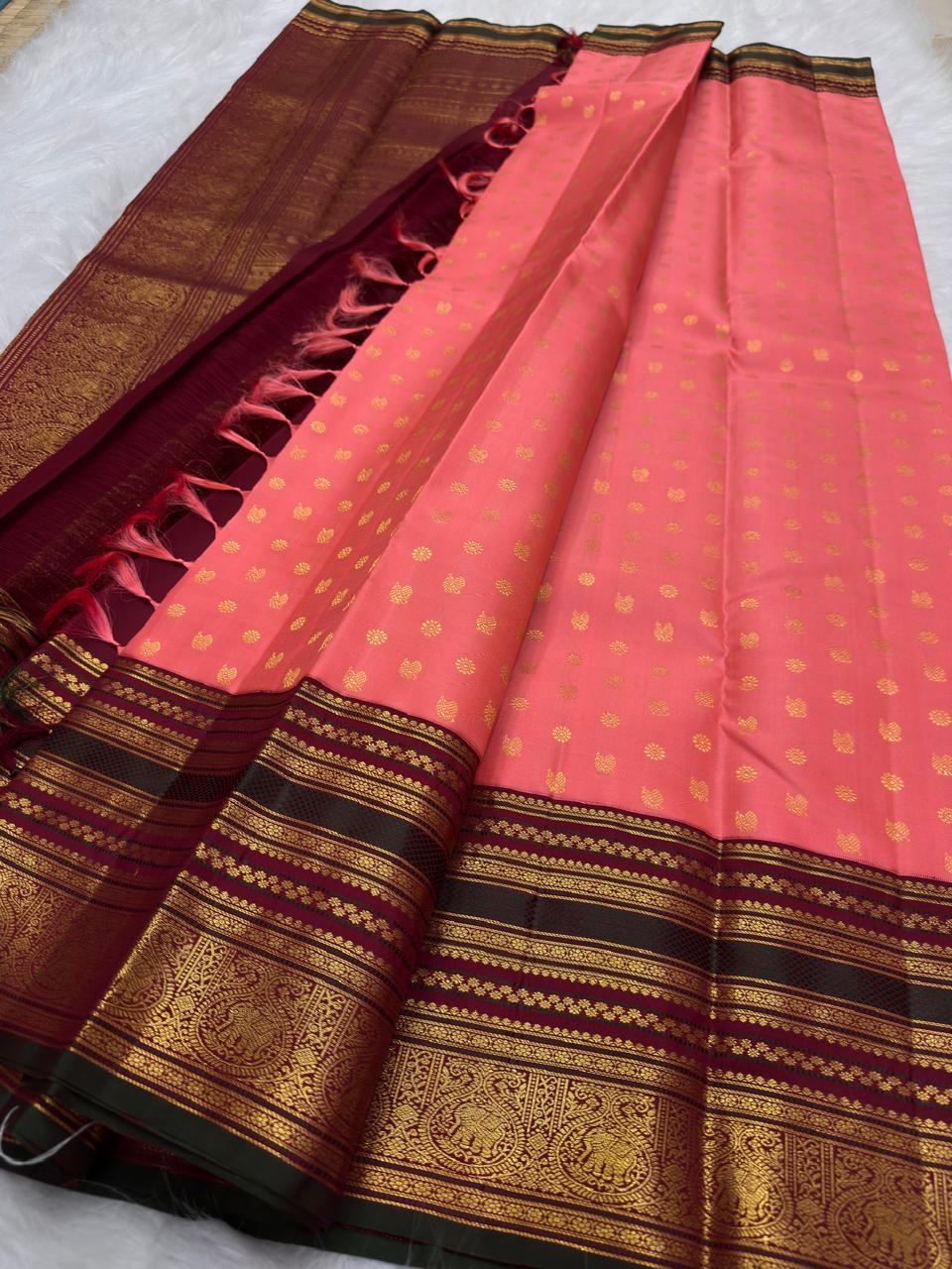 Korvai elephant zari border close-up on Coral Peach Kanchi Pattu silk saree
