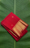 Pure Kanchipuram silk saree in kungumam red with antique gold zari border and traditional zari buttas