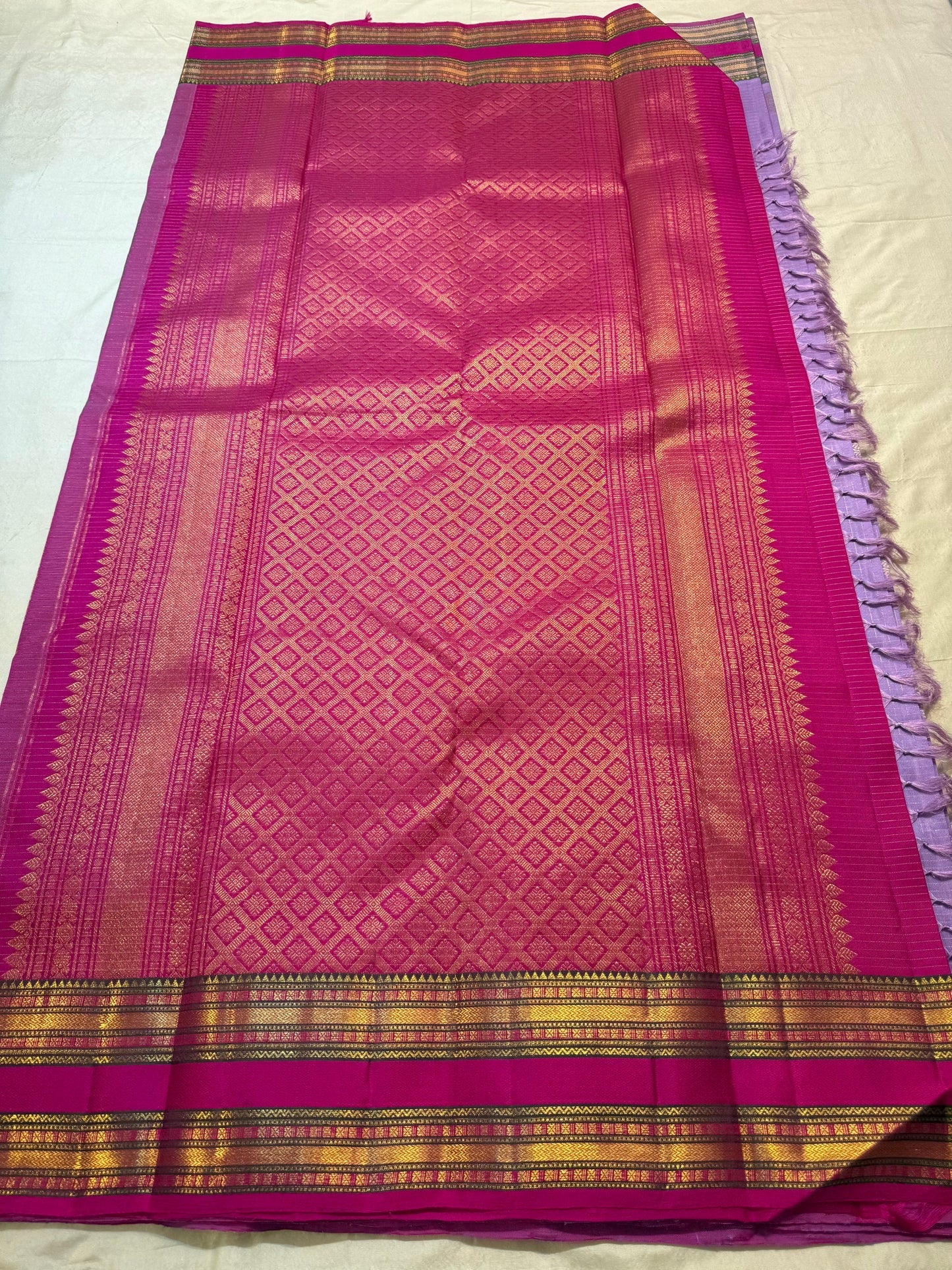 Close view of Lavender Purple Zari Kattam pure silk saree with circular and traditional woven buttas.