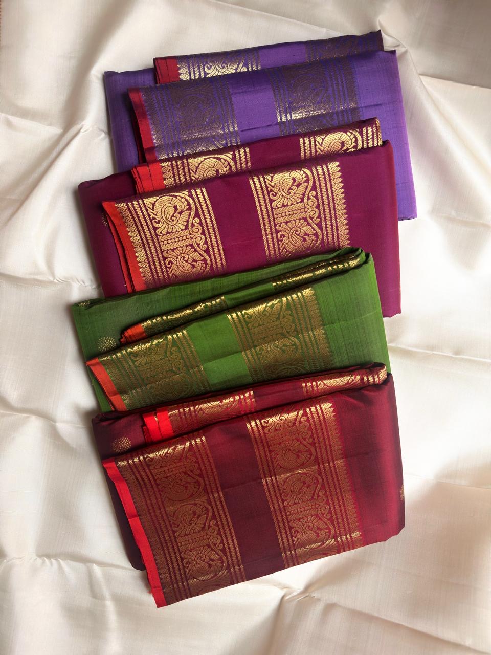 Leaf green pure silk Kanchipuram saree with peacock archway border and gold zari buttas