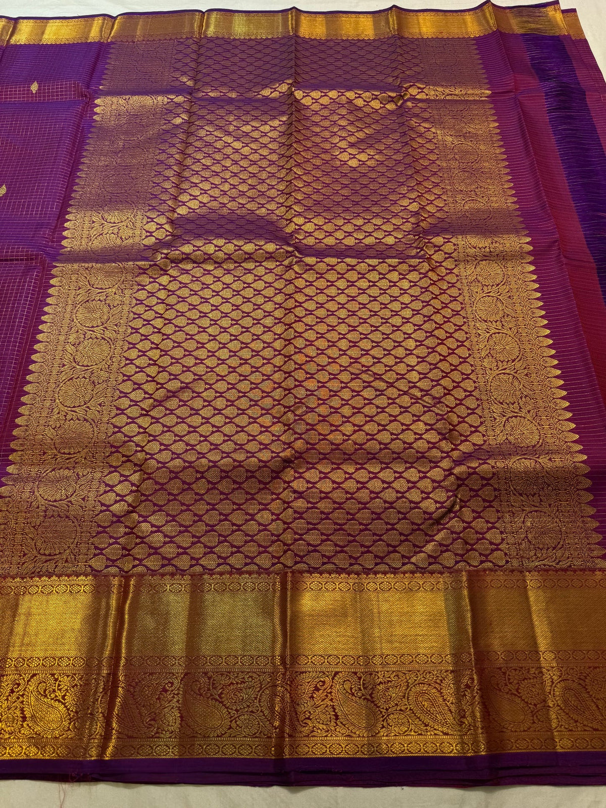 Broad paisley motif gold zari border on magenta Kanchipuram silk