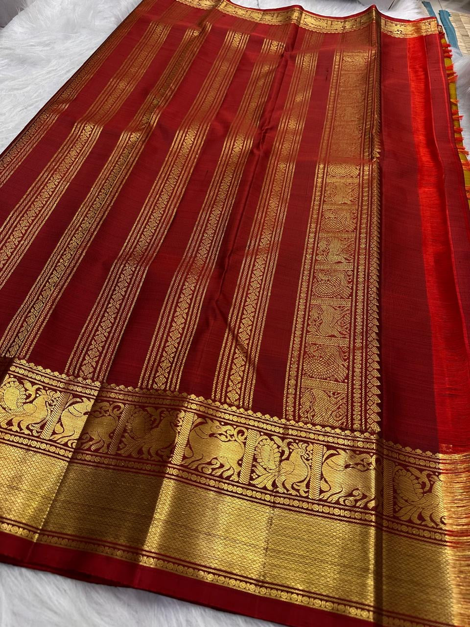 Close view of the deep Arakku pettu with bold Yazhi-inspired motifs and rich gold zari detailing.