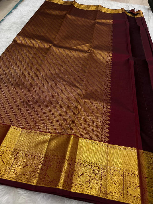 Wide gold zari peacock-and-bird border close-up