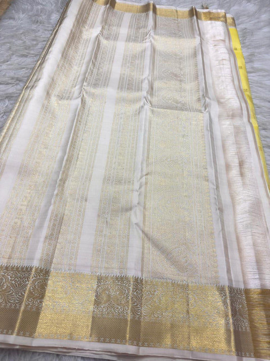 Mellow Manjal yellow Pure Silk Kanjeevaram Butta saree with ivory border
