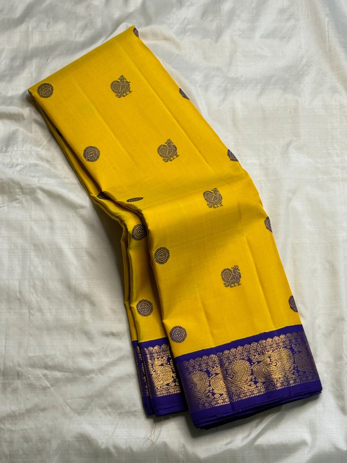 Full view of mustard yellow handwoven Kanchipuram silk saree with silk thread mayil butta and korvai border — Idam Living