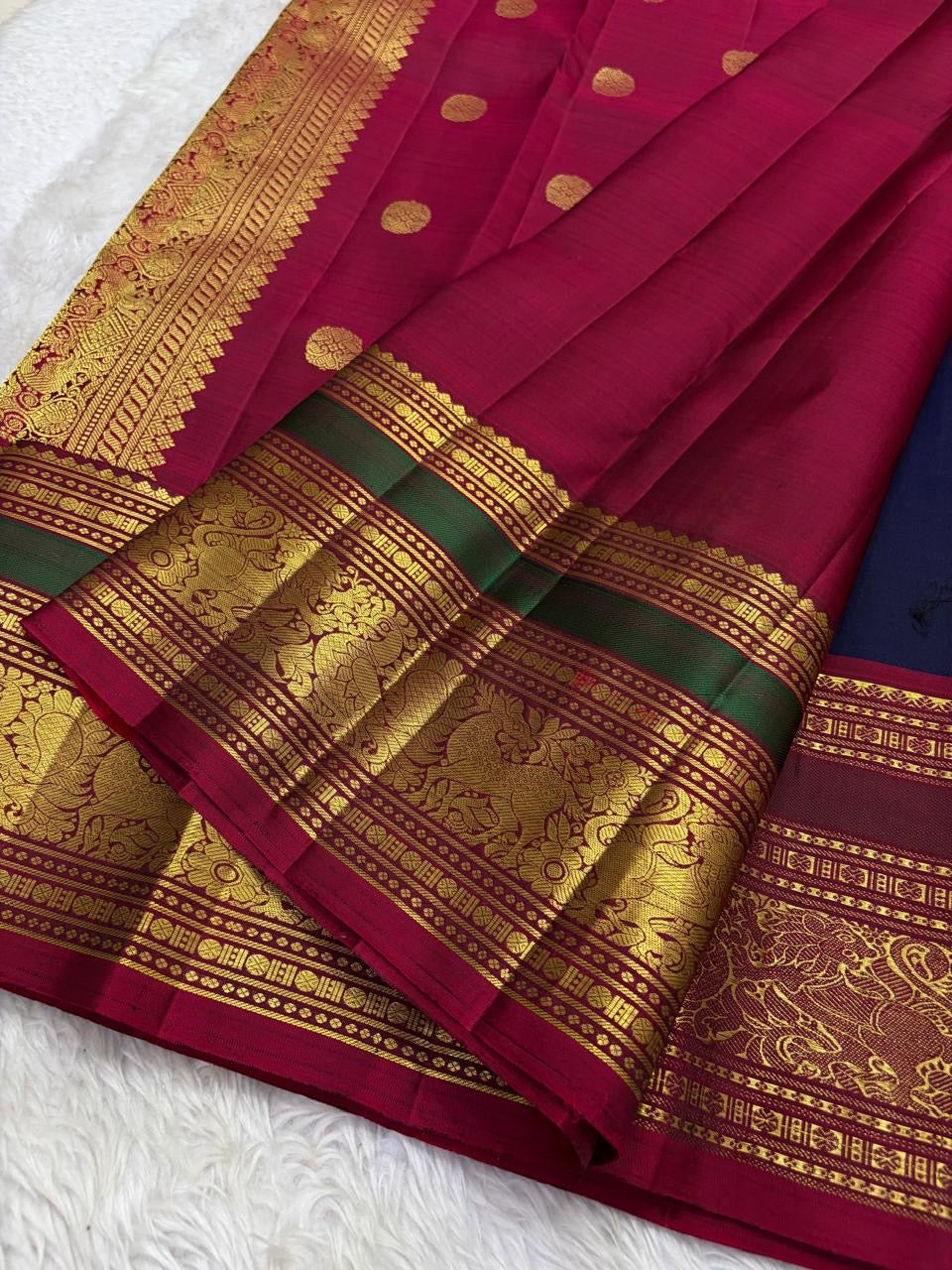 Detail of ornate gold zari Yaanai Ambari elephant procession Butta woven across navy blue Kancheepuram silk body