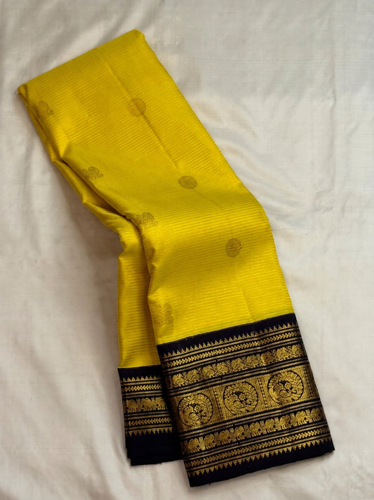 Navy Varisaipet border with repeated gold zari and silk-thread bands on yellow silk