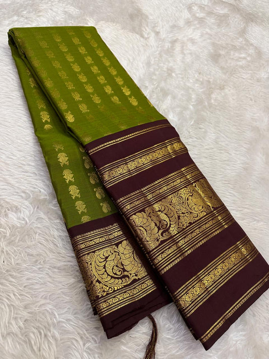 Olive green Kanchi Pattu silk body close-up showing petite mayil chakram butta motifs
