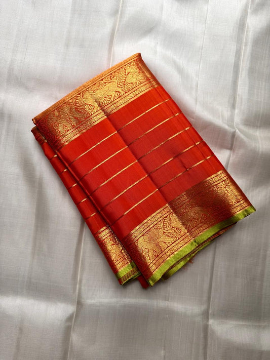 green selvedge border detail of resplendent orange Kanchipuram silk saree