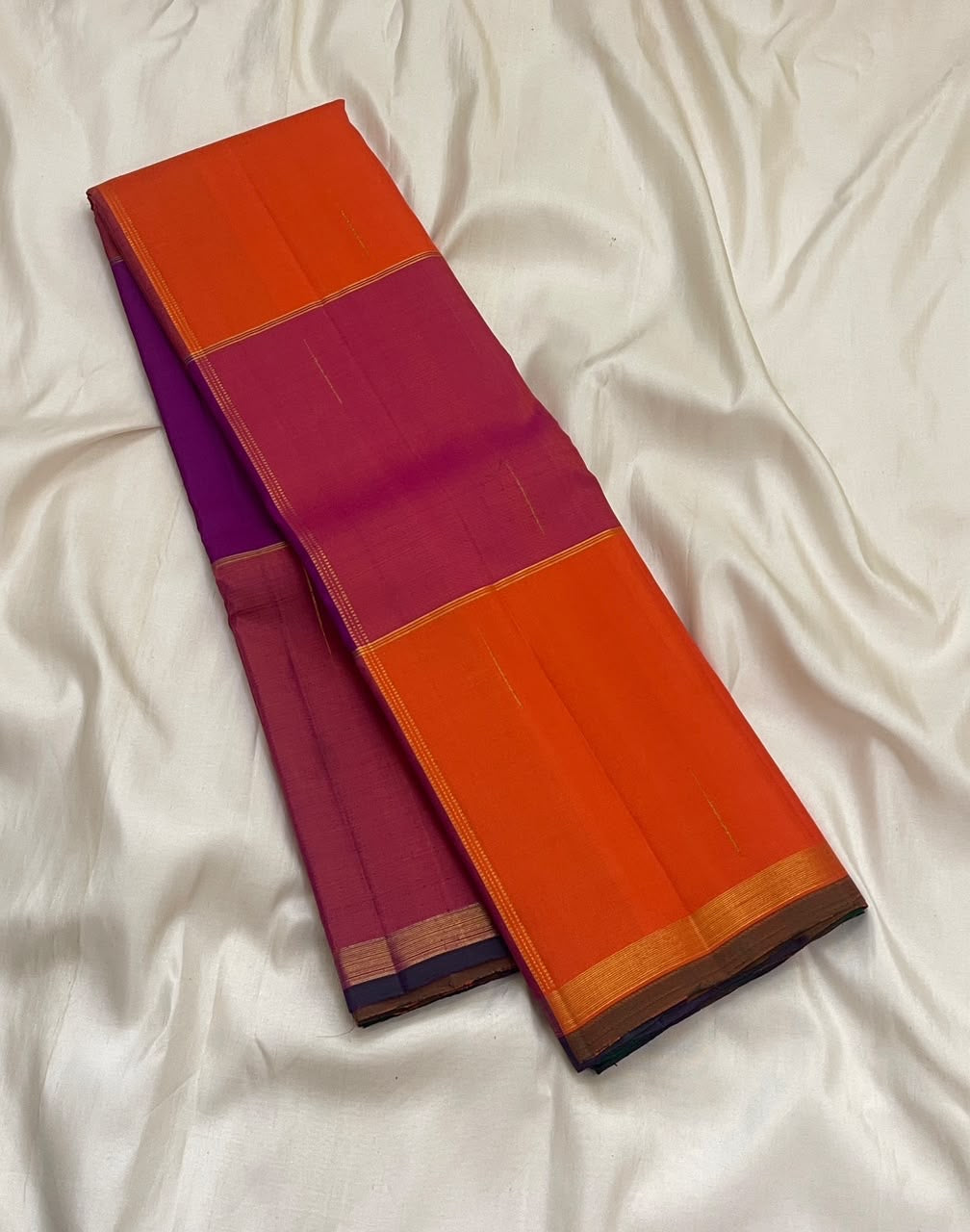 Orange and pink Kanchi Kattam pure silk saree draped to show the checks