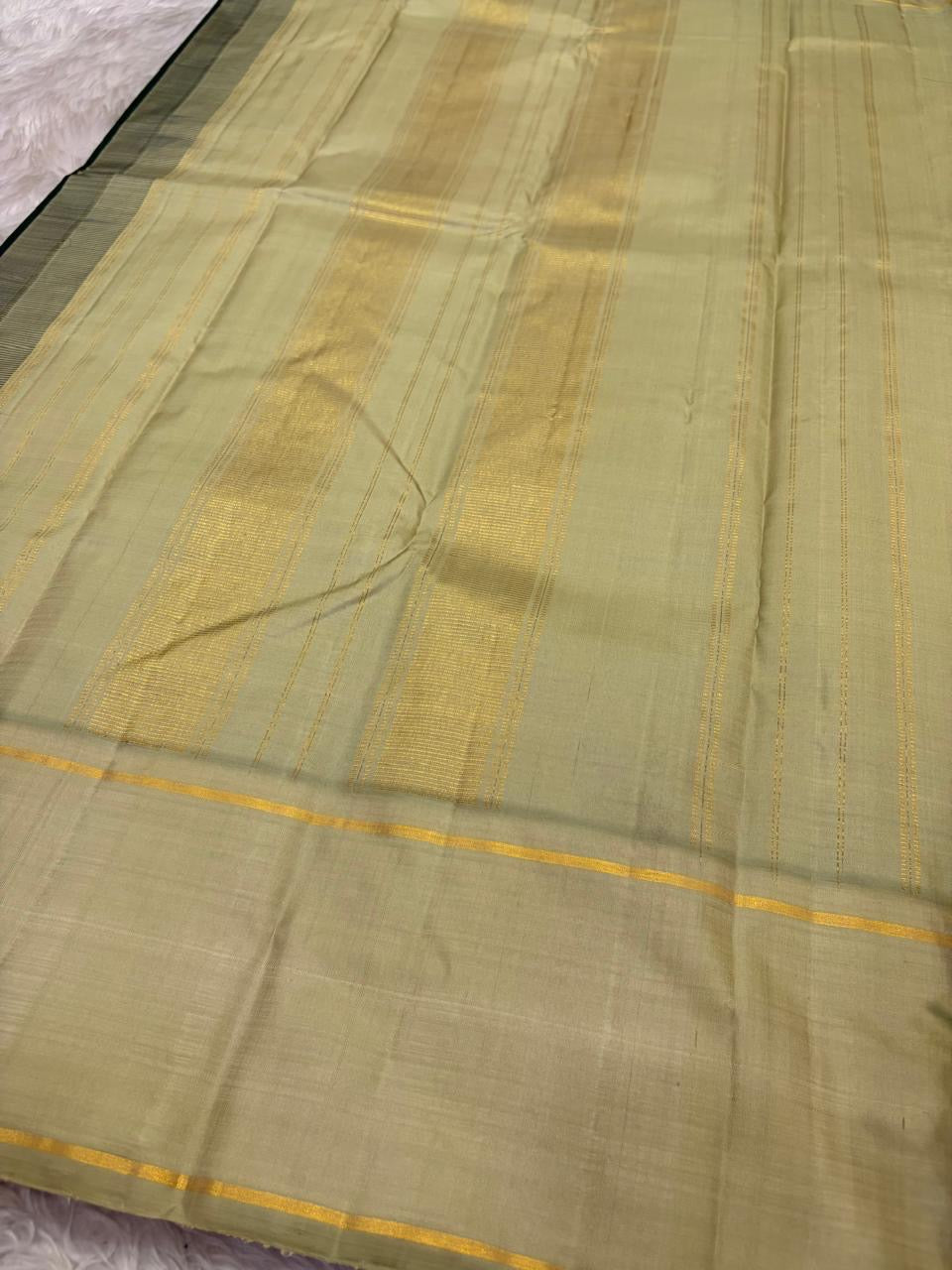 Kancheepuram pure silk saree in pale sage with bottle green contrast border and woven pallu