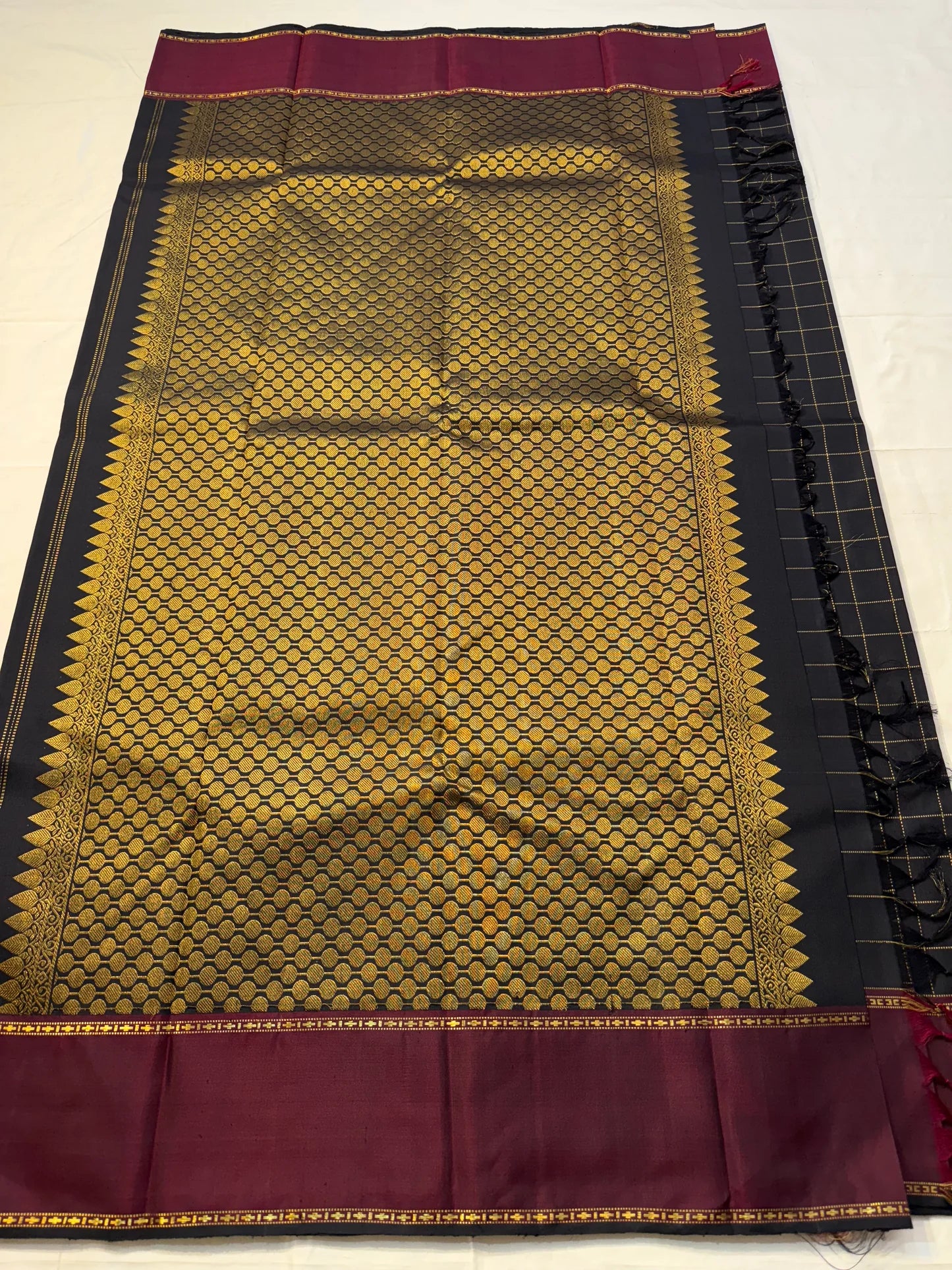 Complete pallu display of Pure Kanchipuram Silk Saree with gold zari honeycomb design, maroon top border, black side checks, and tassel finish (shipped from New Jersey USA)