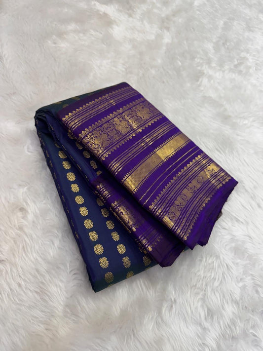 Deep peacock blue Kanjivaram silk saree with petite mayil chakram butta and purple pallu β Idam Living