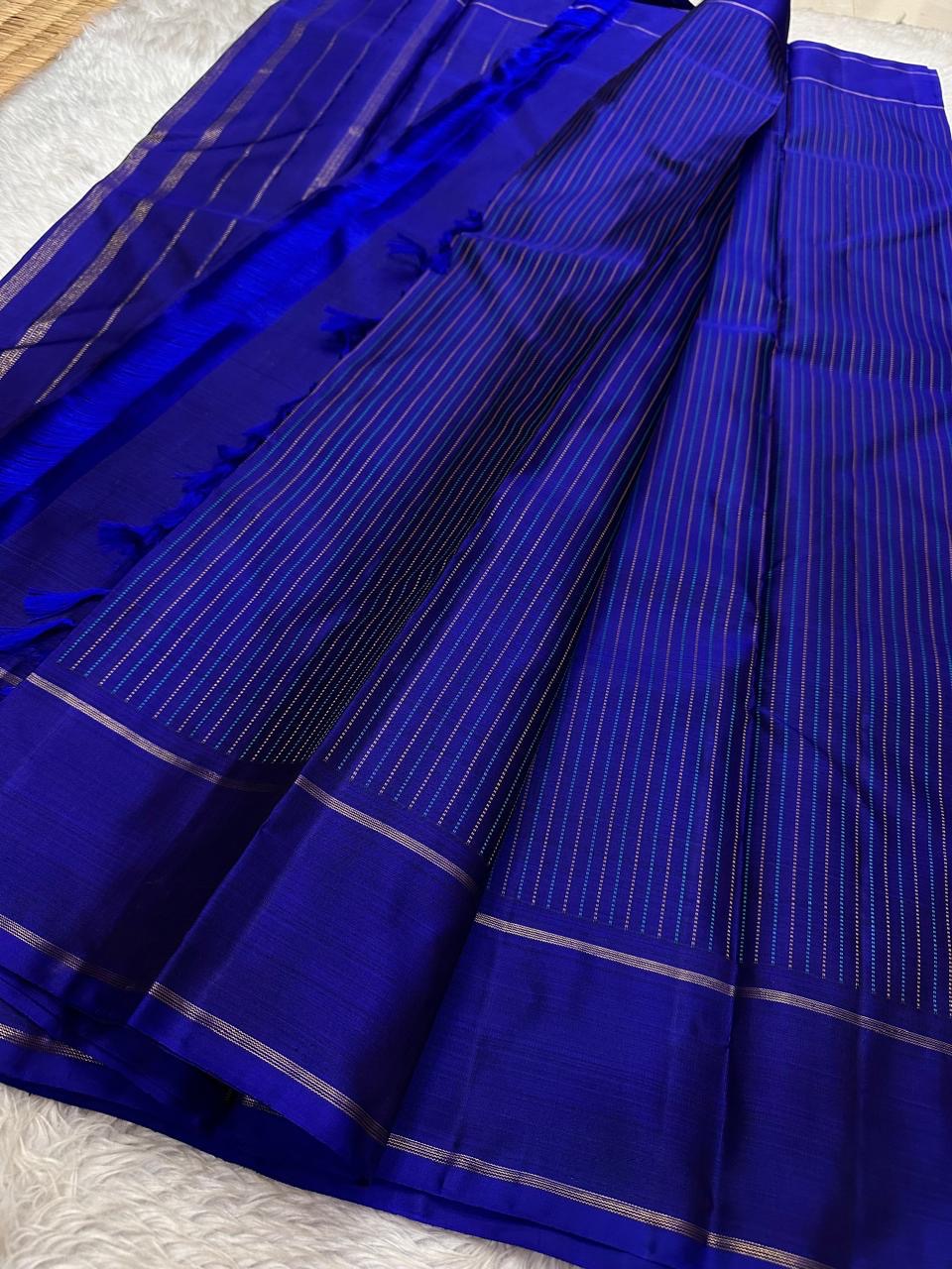 Minimalist blue Kancheepuram silk saree with refined gold zari detailing and timeless South Indian weave aesthetic