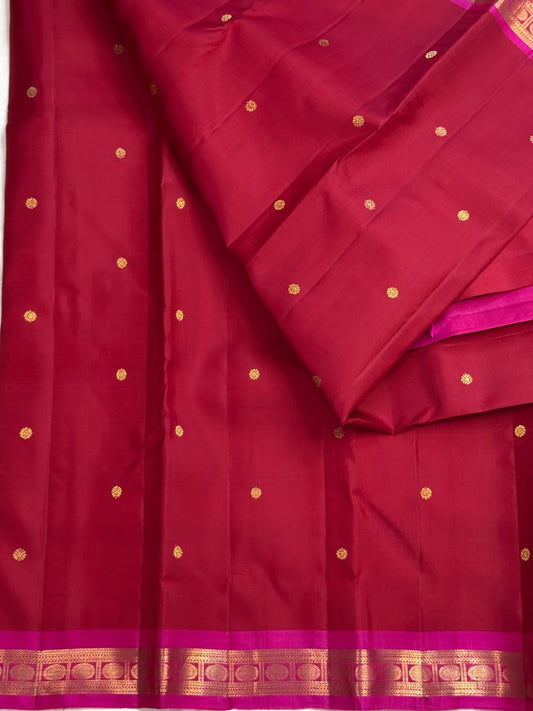 Peacock teal zari pallu of raspberry red Kanchipuram silk saree