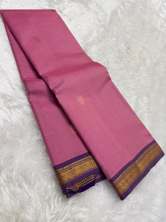 Rose pink Pure Kanchipuram Silk Saree drape with gold buttas and purple zari border on white fur background