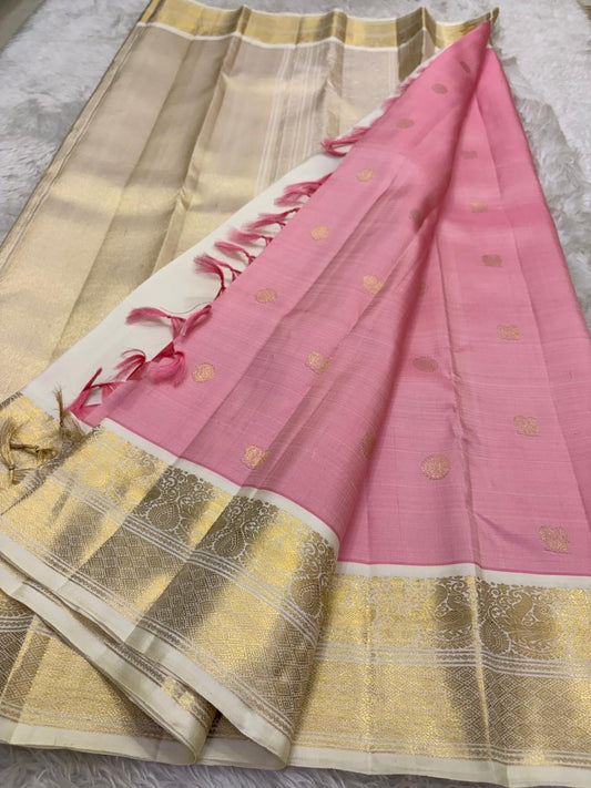 Blush rose pink korvai Kanjivaram silk saree with muted antique gold zari and heritage ivory border