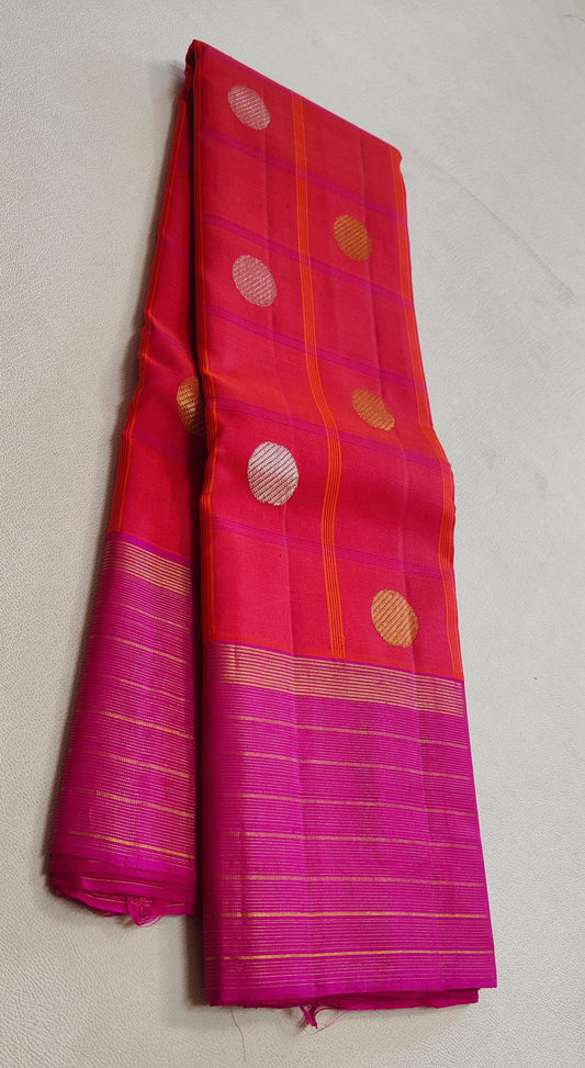 pink red kanchipuram silk saree folded showing antique gold butta and zari border