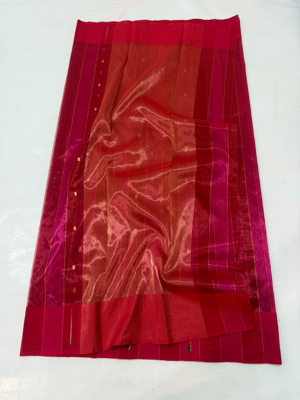 Close-up of the Muniya-style painted border on a Rani Pink Tissue Silk Chanderi saree
