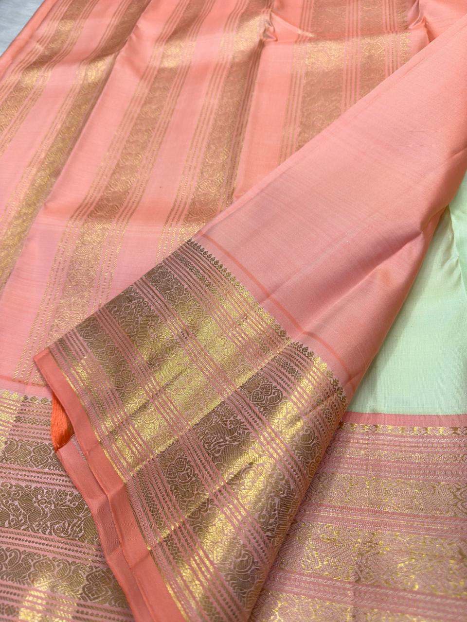Pista Pachai pure silk Kanchipuram Varisaipet saree with petite zari buttas and lotus-peach contrast pettu.