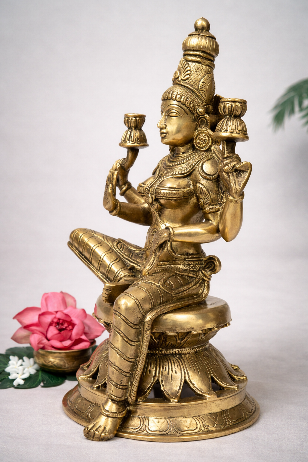 Side profile of 30 cm pure brass Lakshmi statue showing detailed arm lamps, ornate jewelry carvings and lotus base.
