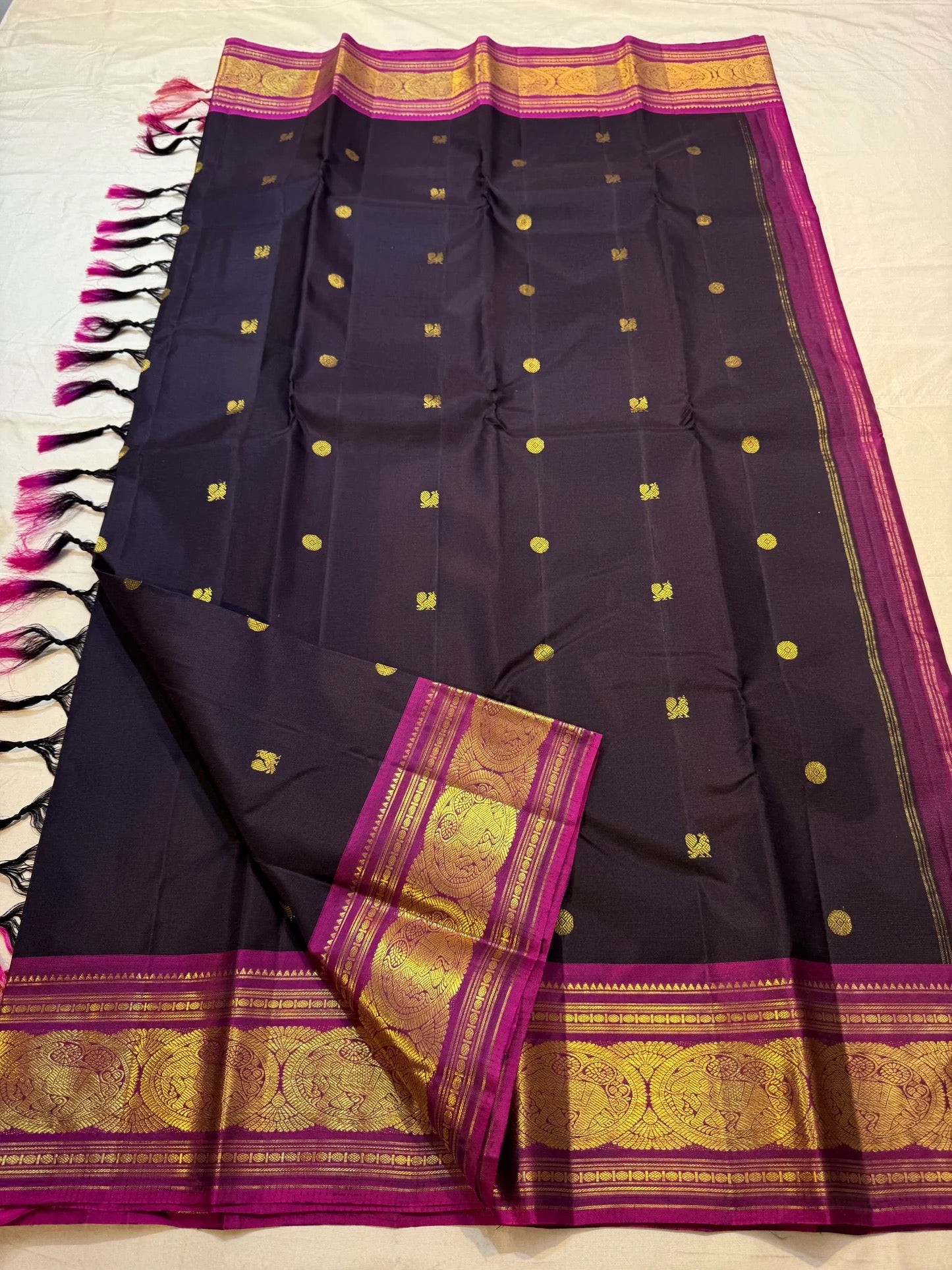 Body close-up of deep aubergine KanchiPattu saree showing petite gold zari buttas