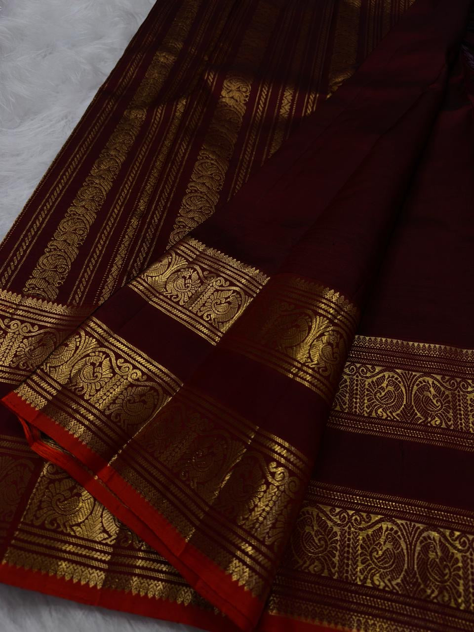 Pure Silk Kanjeevaram saree in chocolate brown, folded showing Rettapet border