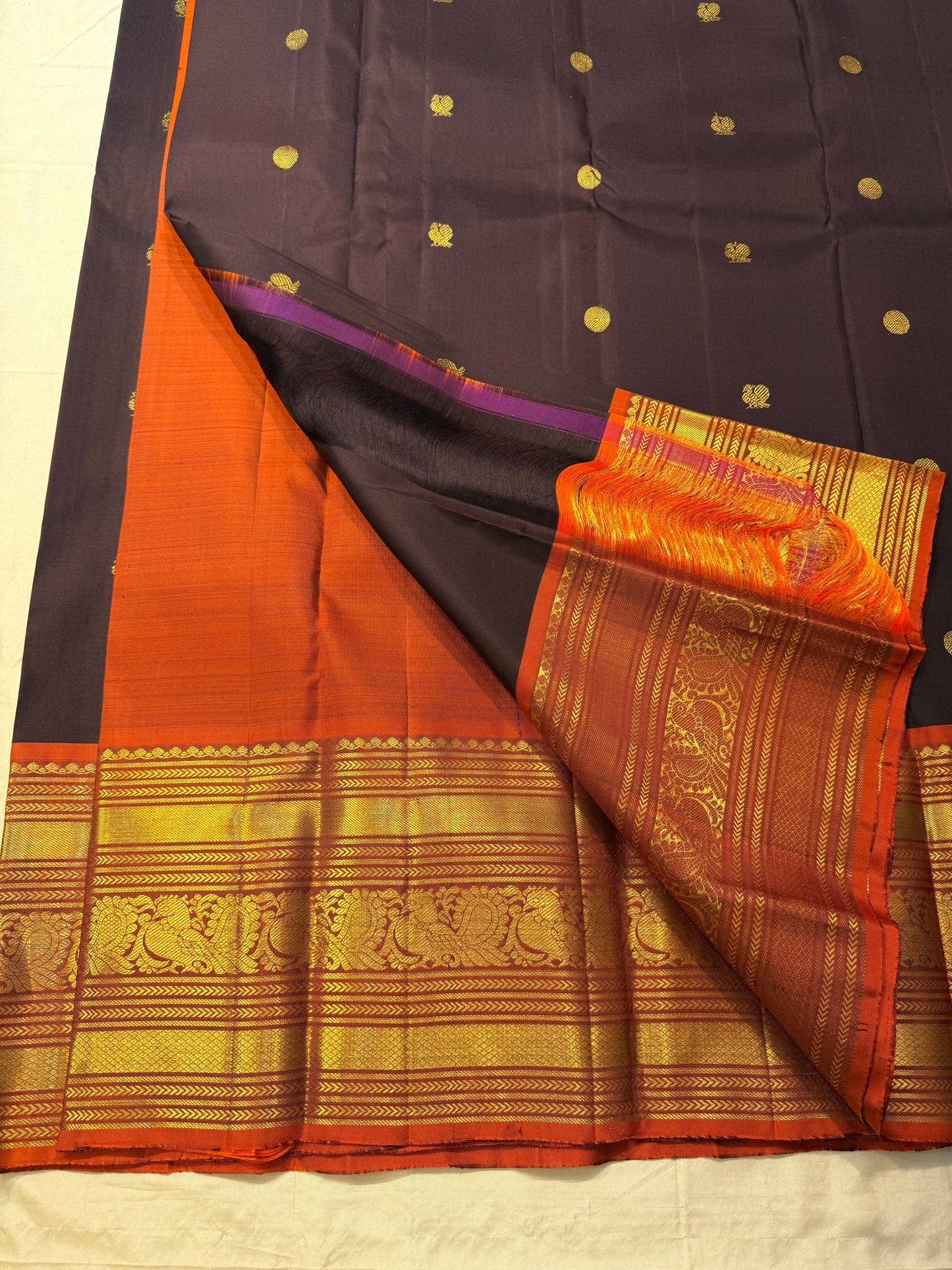 Hand woven Kanchipuram silk saree with dark cocoa purple body and zari motifs