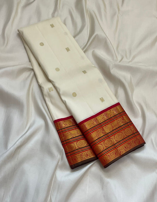 Ivory Pure Kanchipuram silk saree featuring classic varisaipet border with antique gold zari bands and red contrast edge