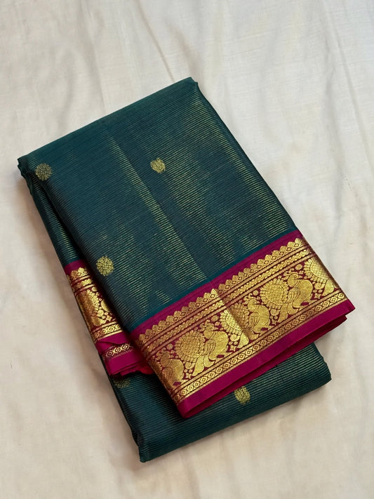 Grand rich pallu with antique-gold zari on a steel-blue pure silk Kanchipuram saree