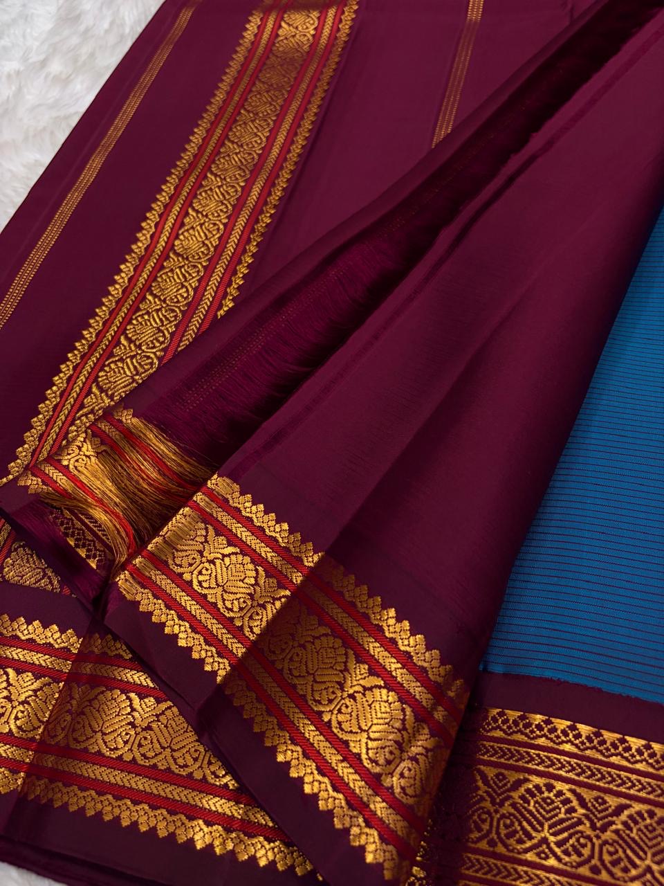 Ramar Blue pure silk Kai Korvai Kanchipuram saree with Arakku pinstripes, silk buttas and gold zari border.