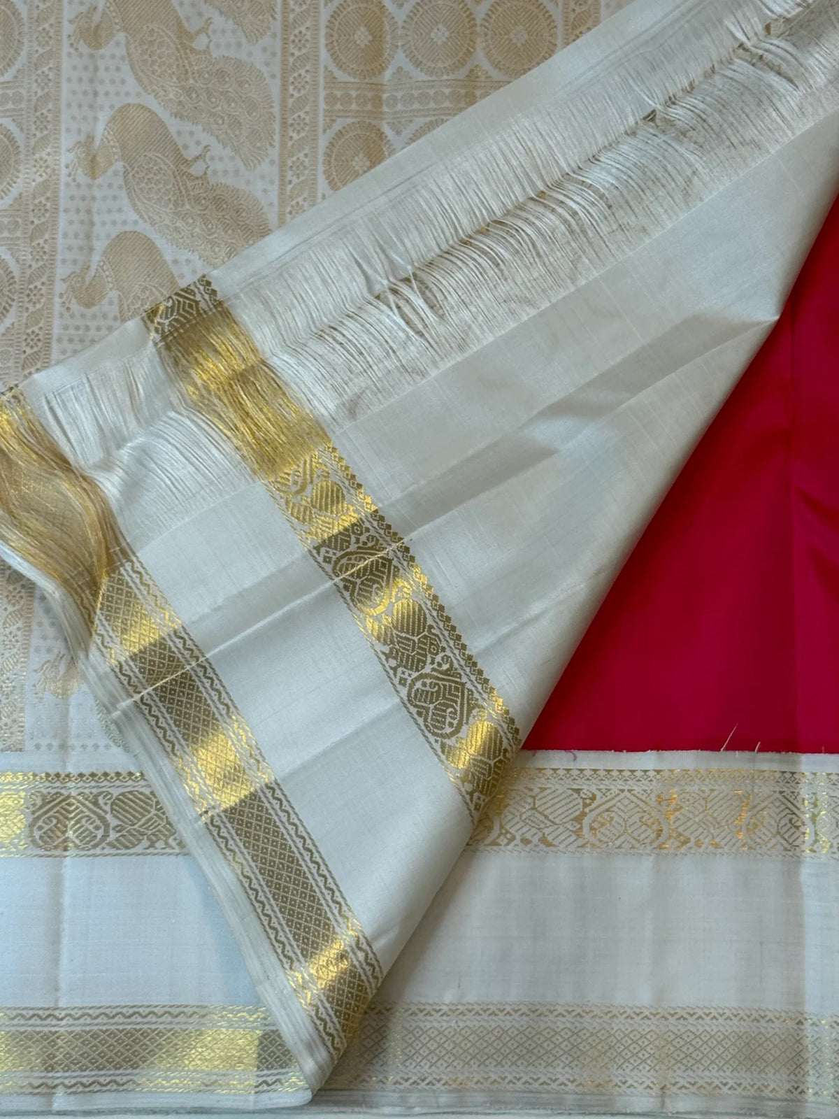 Rani pink Kanjeevaram silk saree with Mayil zari detail
