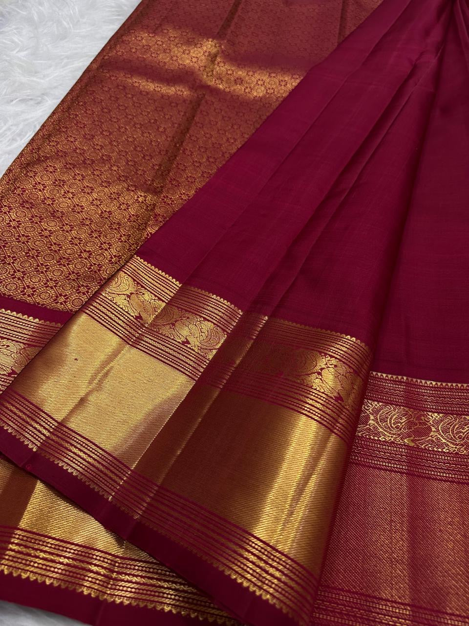 Floral-scroll classic-gold zari detailing across the substantial traditional border.