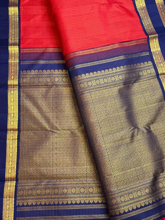 Deep neelam-blue pallu and border with Rudhraksham-inspired detailing on a deep vibrant red Kanchipuram silk saree.